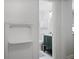 Hallway view of a half bathroom with blue vanity, white walls, and a decorative shelf at 2515 Ridgewood Nw Rd, Atlanta, GA 30318