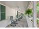 Inviting front porch featuring rocking chairs, ceiling fans, and a gray wooden deck at 2515 Ridgewood Nw Rd, Atlanta, GA 30318