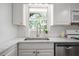 Bright kitchen featuring marble countertops, white subway tile backsplash, and modern stainless steel appliances at 2515 Ridgewood Nw Rd, Atlanta, GA 30318