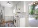 Well-lit kitchen with white cabinets, marble countertops, stainless steel appliances, and a view of the outdoor deck at 2515 Ridgewood Nw Rd, Atlanta, GA 30318