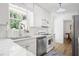 Bright kitchen featuring marble countertops, white subway tile backsplash, and modern stainless steel appliances at 2515 Ridgewood Nw Rd, Atlanta, GA 30318