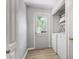 Clean laundry room featuring modern appliances, ample storage, and a convenient access door to the outdoors at 2515 Ridgewood Nw Rd, Atlanta, GA 30318