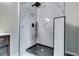 Contemporary shower featuring marble-tiled walls, modern fixtures, and a sleek glass door at 2932 Valley Ridge Dr, Decatur, GA 30032