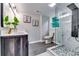 Bathroom featuring a rainfall shower head, glass door and accent wall tiles at 2932 Valley Ridge Dr, Decatur, GA 30032