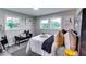 This bedroom has a black accent seat at the foot of the bed, and art on the wall to complement the bedroom at 2932 Valley Ridge Dr, Decatur, GA 30032
