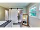 Bedroom featuring comfortable bed and sliding door to remodeled bathroom at 2932 Valley Ridge Dr, Decatur, GA 30032