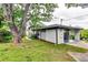 Charming home featuring a covered carport, lush lawn, mature trees, and tasteful landscaping at 2932 Valley Ridge Dr, Decatur, GA 30032