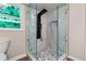 Modern bathroom boasts a glass-enclosed shower with a black shower system and stylish marble tile surround at 2932 Valley Ridge Dr, Decatur, GA 30032