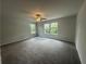 Bright, airy bedroom with large windows overlooking trees, plush carpet and a ceiling fan at 35 Yellow Brick Way, Covington, GA 30014