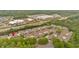 An aerial view of a residential neighborhood with a community pool surrounded by lush green trees and nearby commercial centers at 1078 Camry Cir, Dallas, GA 30157