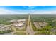 Drone shot of a neighborhood near commercial areas, with roads lined with trees, under a sunny, blue sky on the horizon at 1078 Camry Cir, Dallas, GA 30157