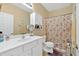 Clean bathroom with white vanity, sink, floral shower curtain, and neutral walls at 1078 Camry Cir, Dallas, GA 30157