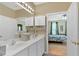 Bathroom with double sinks, vanity, and mirrors leading to bedroom at 1078 Camry Cir, Dallas, GA 30157