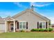Charming home with gray siding, brick entry, manicured lawn, and decorative shrubs at 1078 Camry Cir, Dallas, GA 30157