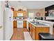 Well-lit kitchen features wood cabinets, white appliances, and ample counter space at 1078 Camry Cir, Dallas, GA 30157