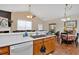Well-lit kitchen with white countertops, stainless steel sink, wooden cabinets, and breakfast bar at 1078 Camry Cir, Dallas, GA 30157