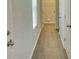 Hallway featuring vinyl floors, utility closet, and a door leading to a bathroom at 115 Deer Xing, Temple, GA 30179