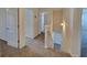 Upstairs hallway with a window that allows for natural light, carpeted floors, and doors to other bedrooms at 115 Deer Xing, Temple, GA 30179