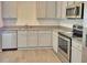 Well-lit kitchen featuring granite countertops, stainless appliances, and ample cabinet space at 115 Deer Xing, Temple, GA 30179