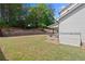 Spacious backyard with mature trees, a lawn, privacy wall and storage shed at 124 Grand Oaks Dr, Canton, GA 30115