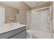 Bathroom featuring a tub/shower combo with glass door, neutral paint and vanity with solid surface countertop at 124 Grand Oaks Dr, Canton, GA 30115