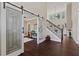 Hardwood foyer highlighting sliding barn doors, staircase, and an open floor plan at 124 Grand Oaks Dr, Canton, GA 30115
