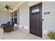 Close up of a welcoming front door with a transom window and a comfortable seating area at 124 Grand Oaks Dr, Canton, GA 30115