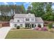 Charming two-story home with landscaped yard, lush green lawn and beautiful flowering shrubs in the flower beds at 124 Grand Oaks Dr, Canton, GA 30115