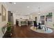 Bright kitchen boasts stainless steel appliances, hardwood floors, and modern lighting fixtures at 124 Grand Oaks Dr, Canton, GA 30115