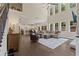 Open-concept living room featuring tall windows, hardwood floors and adjoined kitchen at 124 Grand Oaks Dr, Canton, GA 30115