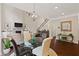 Bright living room with hardwood floors, fireplace, staircase, and dining area at 124 Grand Oaks Dr, Canton, GA 30115