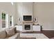 Living room with fireplace, built-ins, and tall ceilings and large windows at 124 Grand Oaks Dr, Canton, GA 30115