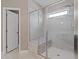 Glass-enclosed shower with bench and sleek design features, highlighting the bathroom's modern style at 124 Grand Oaks Dr, Canton, GA 30115