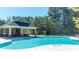 A refreshing pool with clear water, surrounded by trees and a covered pavilion with seating area at 124 Grand Oaks Dr, Canton, GA 30115