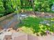 Expansive backyard with lush greenery, a fire pit area, and a wooded perimeter, offering a private outdoor retreat at 1379 Branchwood Dr, Snellville, GA 30078