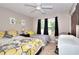 Comfortable bedroom featuring two beds, neutral tones, a ceiling fan, and natural light, creating a cozy retreat at 1379 Branchwood Dr, Snellville, GA 30078