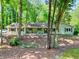 Charming single-story home featuring a well-maintained front yard and beautiful mature trees at 1379 Branchwood Dr, Snellville, GA 30078
