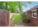 View of a backyard with a freshly cut lawn and new fence, side of house at 2771 Stonecreek Se Rd, Smyrna, GA 30080