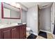 Clean bathroom with a sink vanity, stone tiled shower, and tile flooring at 2771 Stonecreek Se Rd, Smyrna, GA 30080