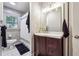 Bright bathroom featuring a modern vanity, tiled shower and window letting in natural light at 2771 Stonecreek Se Rd, Smyrna, GA 30080