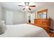 Bedroom boasts a comfortable bed, hardwood floors, and a wooden dresser with mirror at 2771 Stonecreek Se Rd, Smyrna, GA 30080