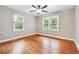 Inviting bedroom with hardwood floors, ceiling fan and natural light from two large windows at 2771 Stonecreek Se Rd, Smyrna, GA 30080