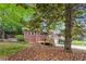 Charming brick home featuring a wood deck, lush landscaping, and mature trees, providing great curb appeal at 2771 Stonecreek Se Rd, Smyrna, GA 30080