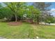 Charming brick home with a well-manicured lawn and mature trees providing shade at 2771 Stonecreek Se Rd, Smyrna, GA 30080