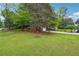 Expansive front yard with mature trees and beautiful landscaping at 2771 Stonecreek Se Rd, Smyrna, GA 30080