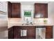 Updated kitchen with stainless steel dishwasher, granite countertops and dark wood cabinetry, creating a modern look at 2771 Stonecreek Se Rd, Smyrna, GA 30080