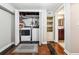 Laundry area with washer, dryer, shelving and a view of a bathroom; ample space for cleaning at 2771 Stonecreek Se Rd, Smyrna, GA 30080
