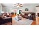Cozy living room showcasing hardwood floors, a ceiling fan, and comfortable leather furniture, perfect for relaxation at 2771 Stonecreek Se Rd, Smyrna, GA 30080