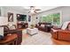 Bright living room with a large window, hardwood floors, leather furniture, and neutral decor, creating a welcoming space at 2771 Stonecreek Se Rd, Smyrna, GA 30080
