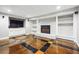 Spacious living area with a stone fireplace, built-in shelves, and unique tiled flooring at 2771 Stonecreek Se Rd, Smyrna, GA 30080
